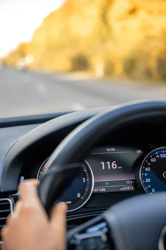 Steering wheel in a car close up, high speed driving on the road.
